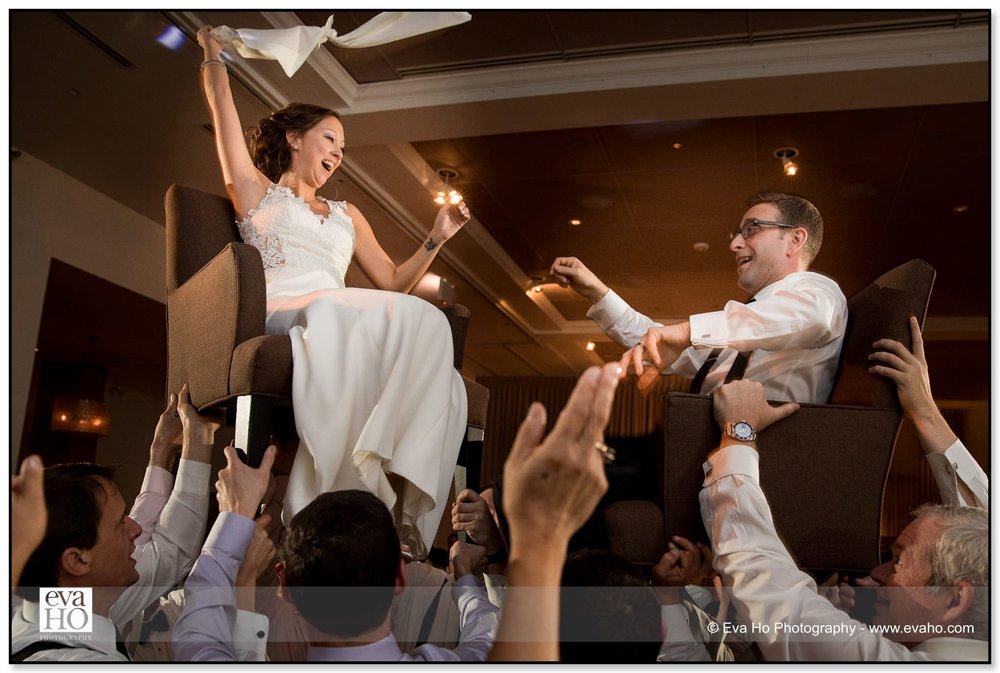 Wedding Guests Lift Bride And Groom Up Into The Air On Their